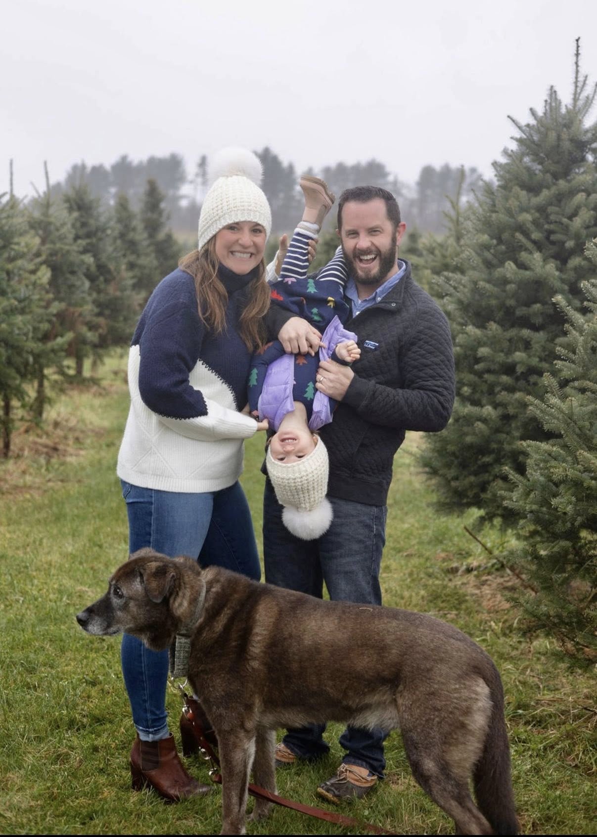 Dr. Nicholas Sherman with family and chocolate Labrador at Christmas tree farm