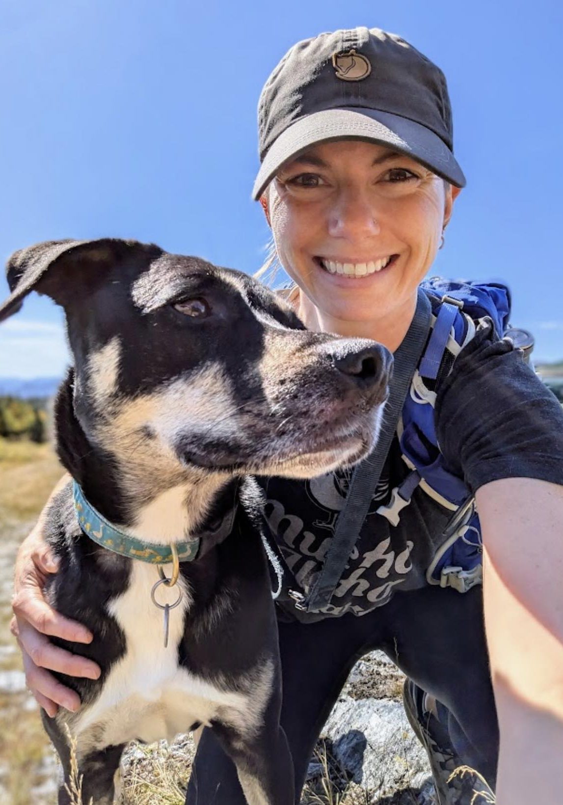 Dr. Miranda Fritz hiking outdoors with Australian Shepherd mix dog in Vermont